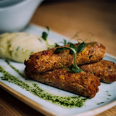 Vegetarian spicy chickpea and coriander sausages, available vegan with olive oil mash